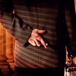 Businessman Crossing Fingers Are Prisons Biblical?